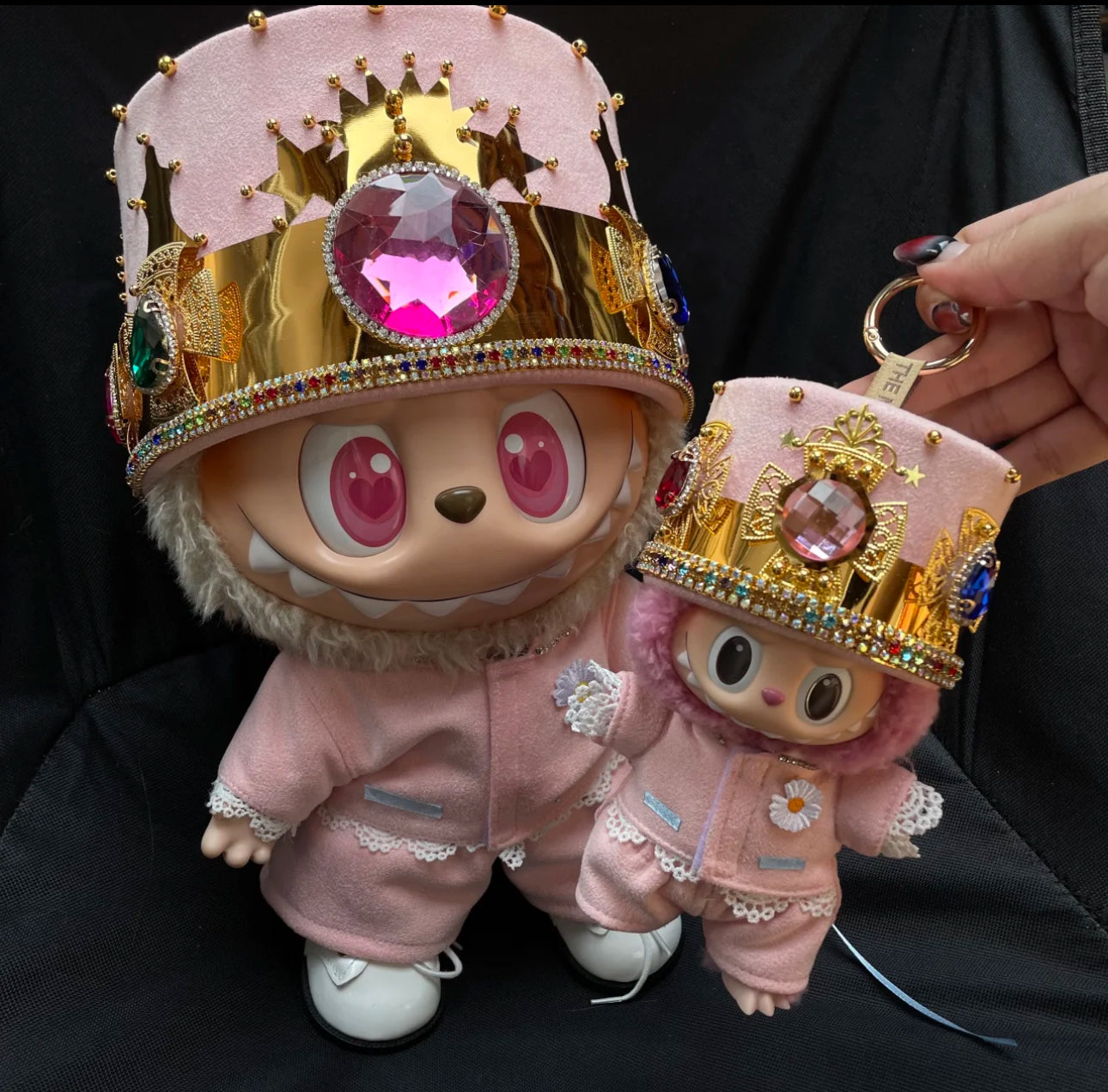 Two Labubu figures wearing pink outfits with a crown, designed to look like a Kpop G-Dragon inspired outfit.