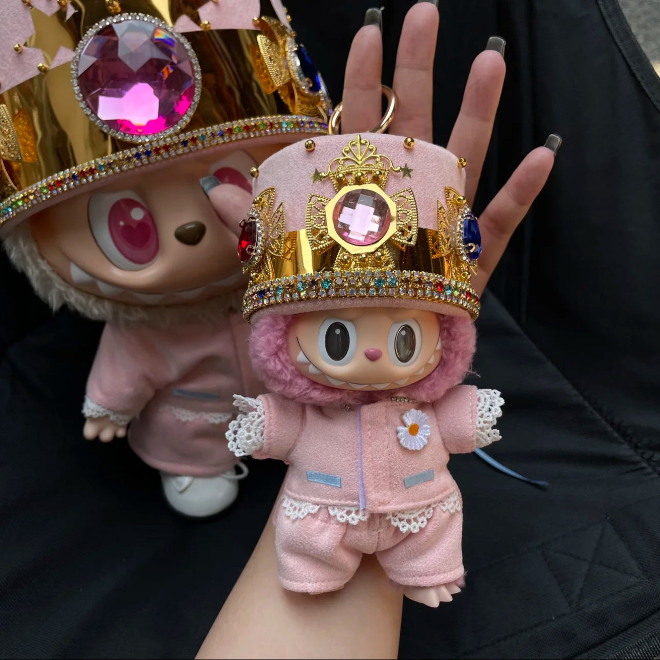 labubu doll dressed in gdragon pink jacket and crown hat
