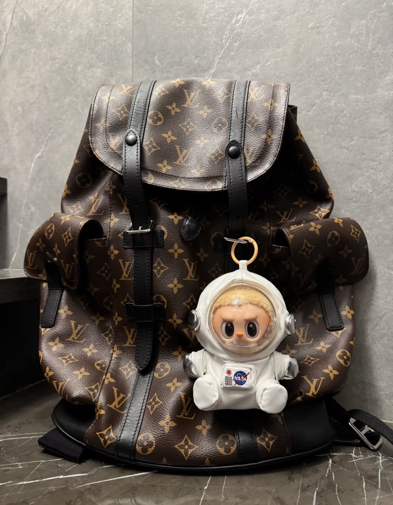 labubu wearing astronaut helmet and galaxy print suit
